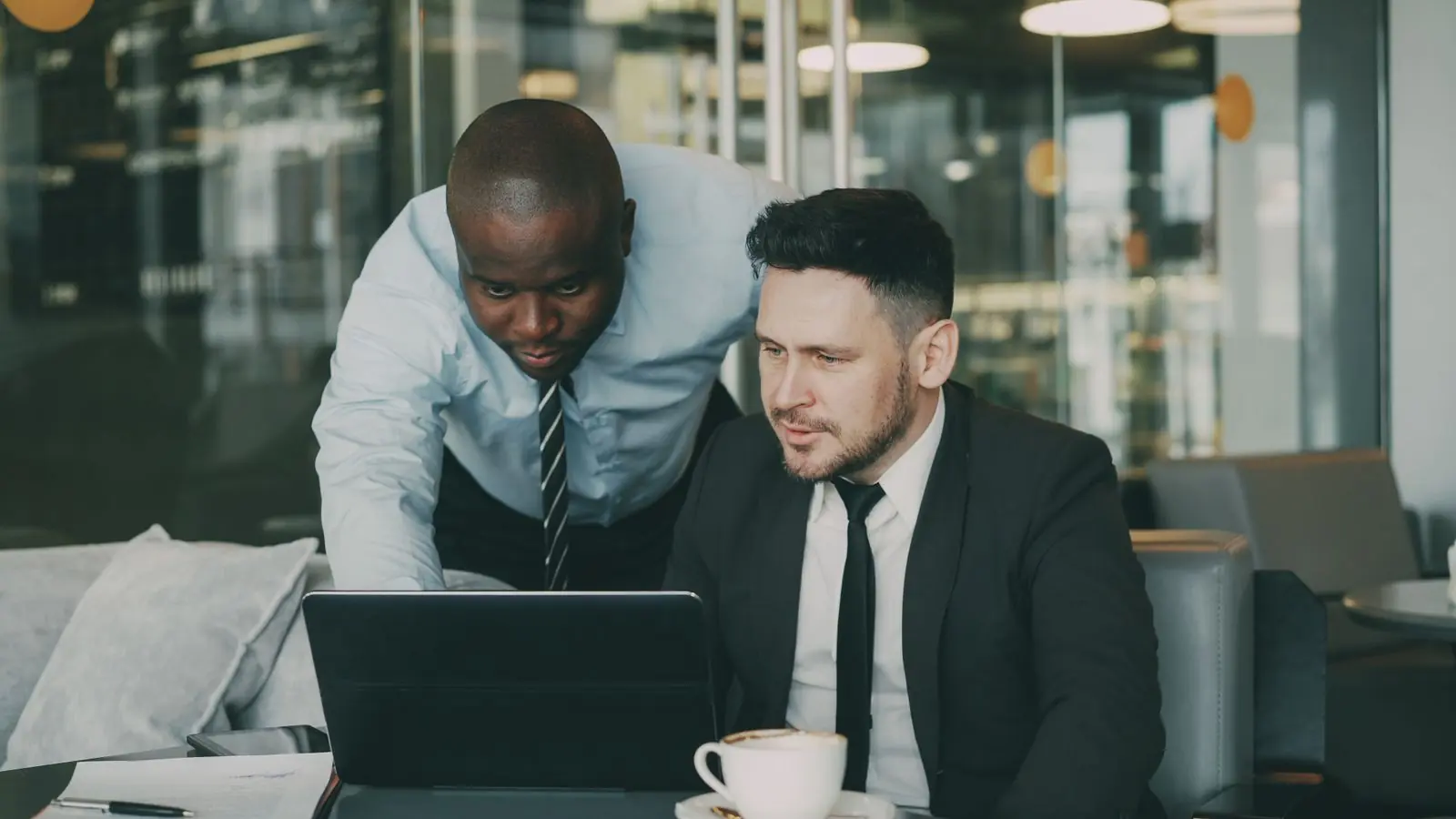 Team collaborating around a laptop during a workflow consulting session